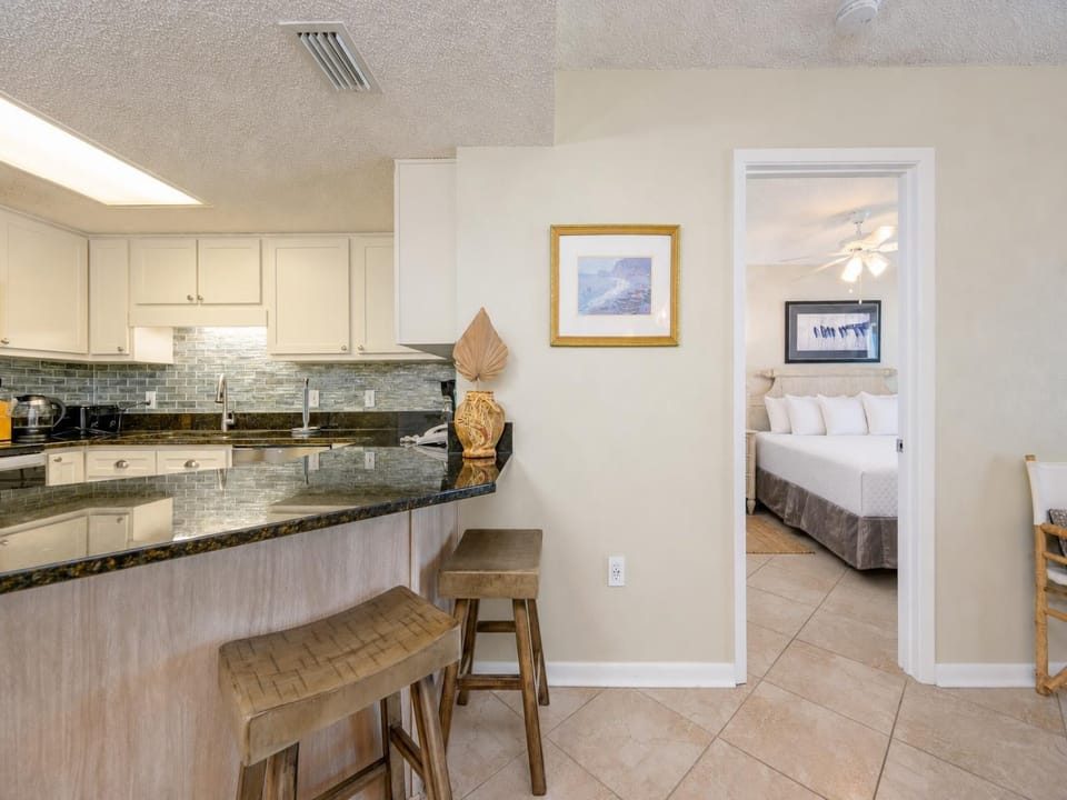 Granite countertops reflect kitchen activity as you prepare snacks before relaxing in the master suite with a king bed