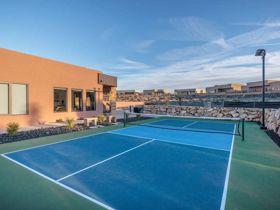 This private pickleball court is located on the side of the house and has outdoor lights for late night fun!