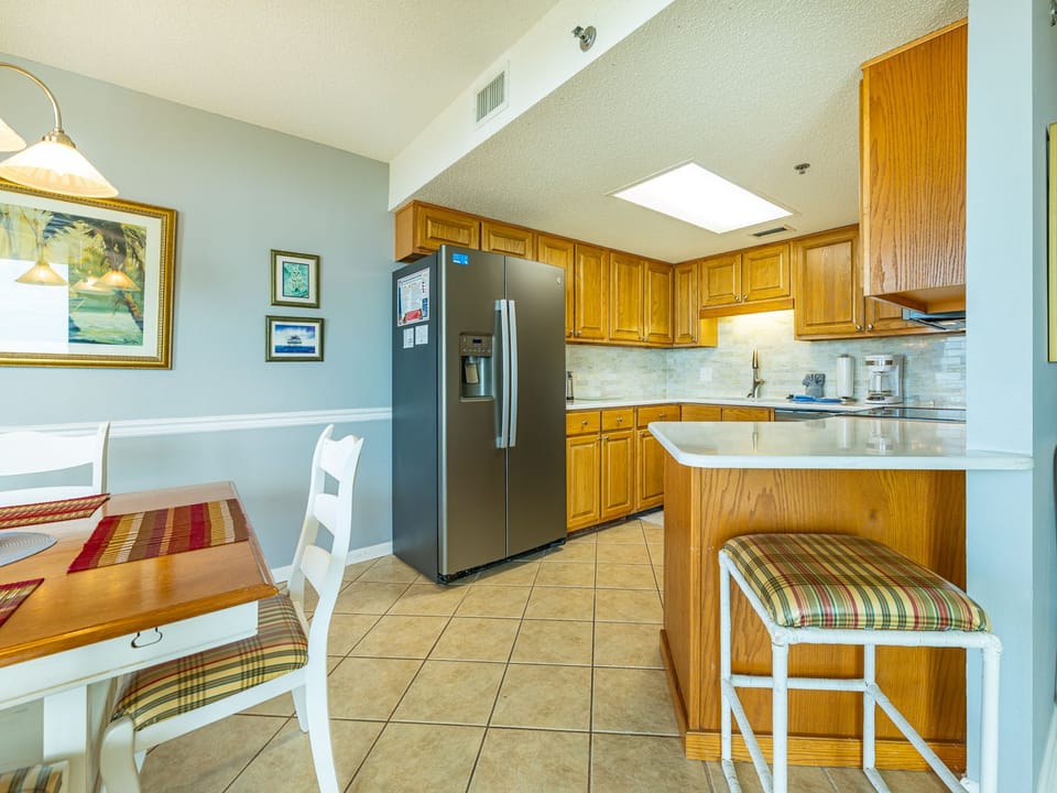 Warm wooden cabinets complement the sleek appliances in this inviting kitchen, ideal for preparing meals during your stay