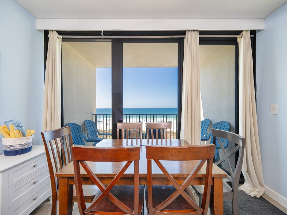 Gather around the dining table, enjoying laughter and conversations while gazing out at the stunning coast view