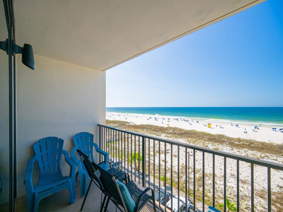 Savor the vibrant beach views as you relax in your seating on the balcony, perfect for unwinding after a day of adventure