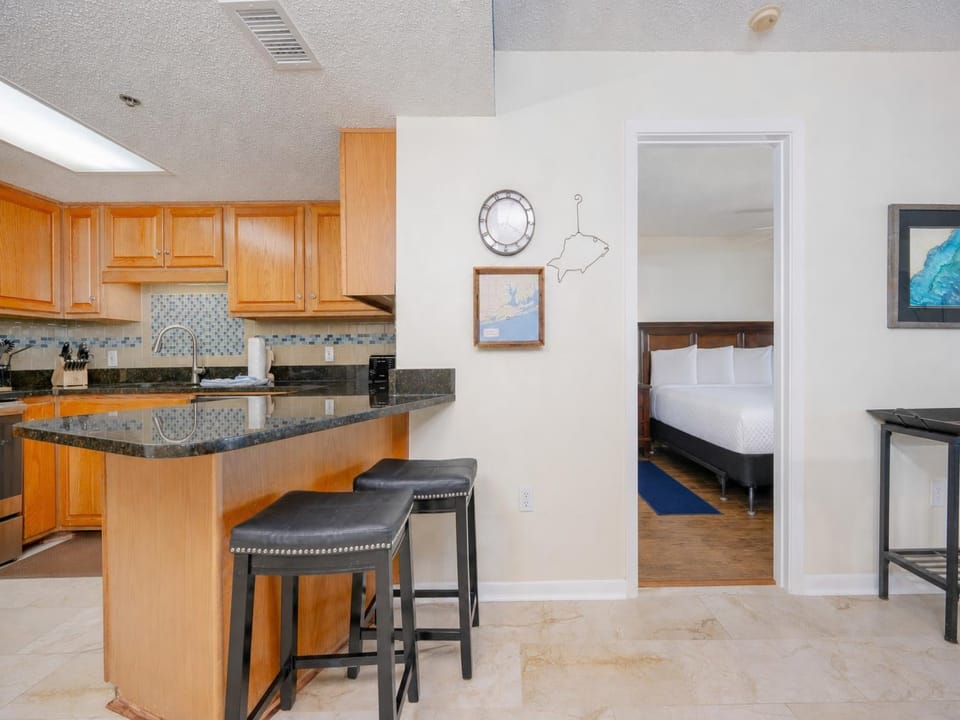 Your kitchen's breakfast bar invites casual meals and lively conversations just steps from the guest suite door