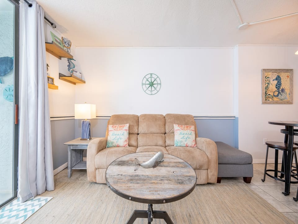 Curl up on the inviting couch and enjoy the coastal decor that brings the beach vibe into your relaxation space