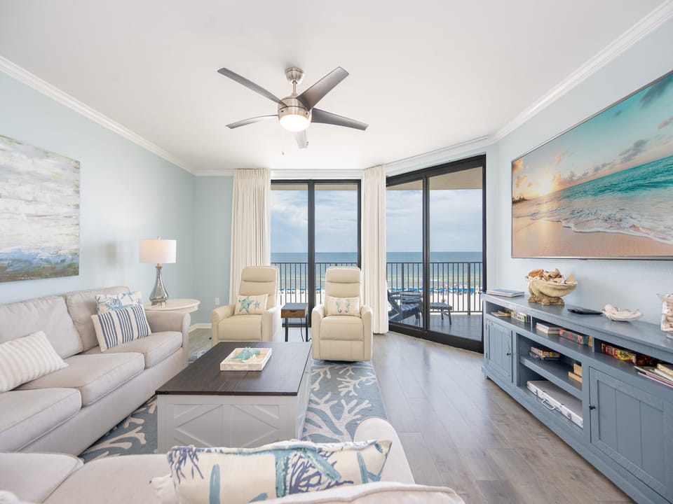 The living room invites you to unwind on the sofa queen while watching waves ripple beyond your balcony door