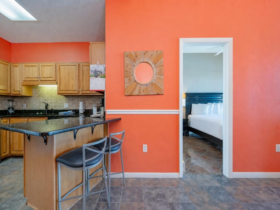 Sunlight washes over the kitchen breakfast bar where you'll sip coffee before retreating to the king master suite