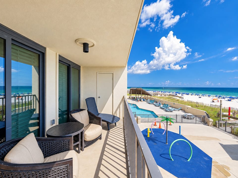 Enjoy the inviting outdoor space with picnic tables and lounge chairs, perfect for relaxing while taking in the beach view