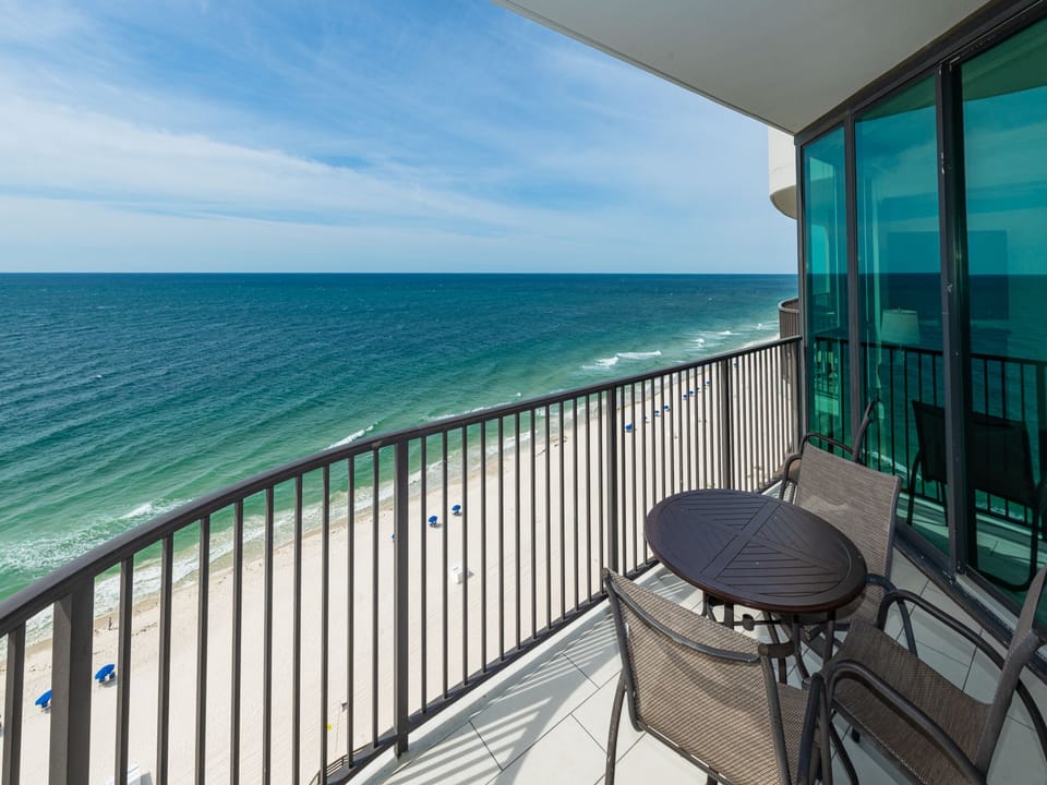 Breathe in the fresh air while enjoying meals at the balcony table with expansive views of the tranquil shoreline