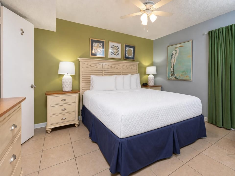 Unwind in the tranquil bedroom featuring a king bed, soft lighting, and coastal decor for a restful stay