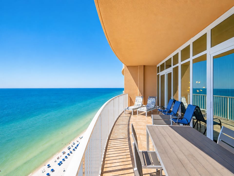 Bask in the sun on the spacious balcony, featuring a dining table and chairs with expansive water views