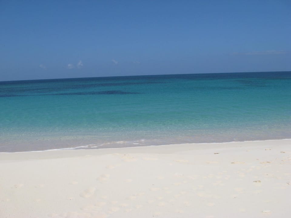 Our beach facing west on a windless day.  There are often waves on the beach that are great for body surfing.