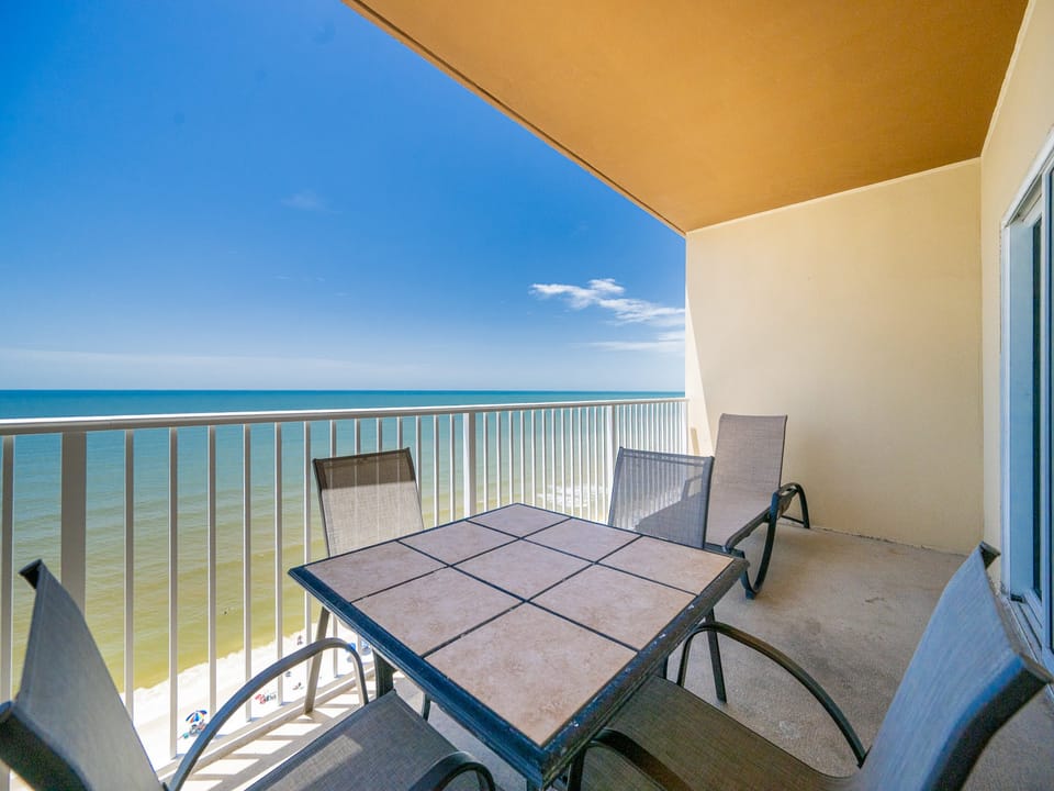 Relax on the balcony with a table and chairs, enjoying breathtaking views of the sparkling turquoise waters