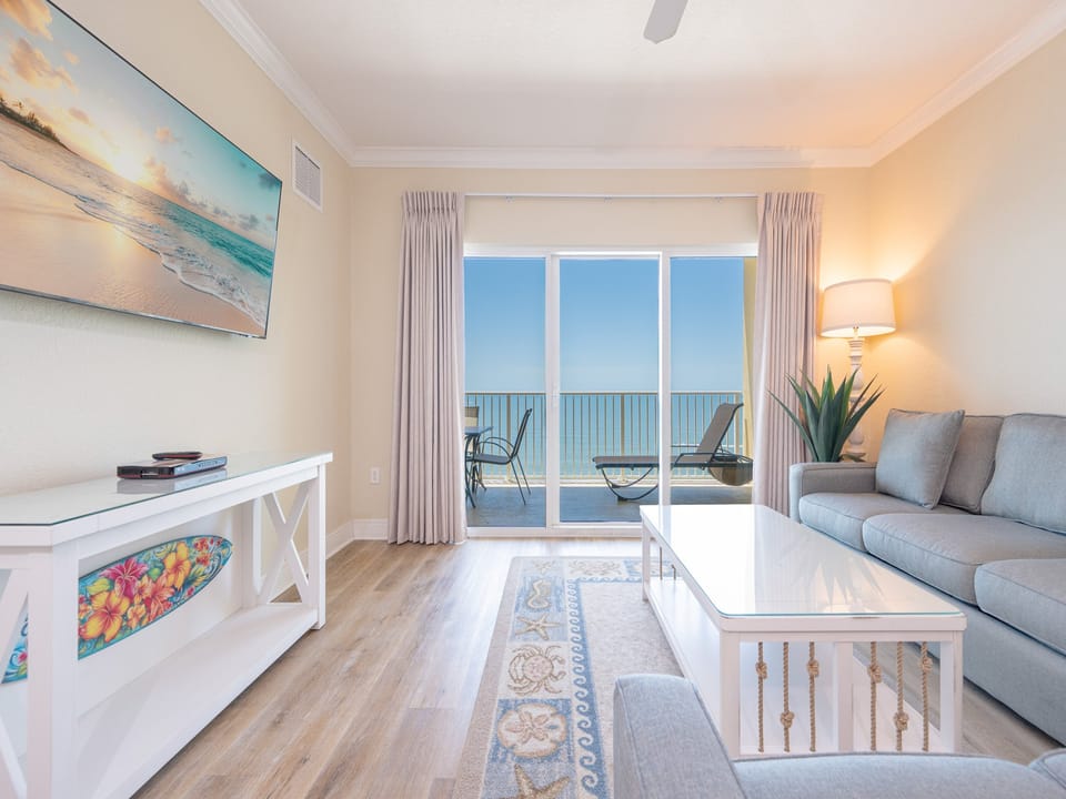 Spacious living room with floor to ceiling windows make for the perfect place to make memories