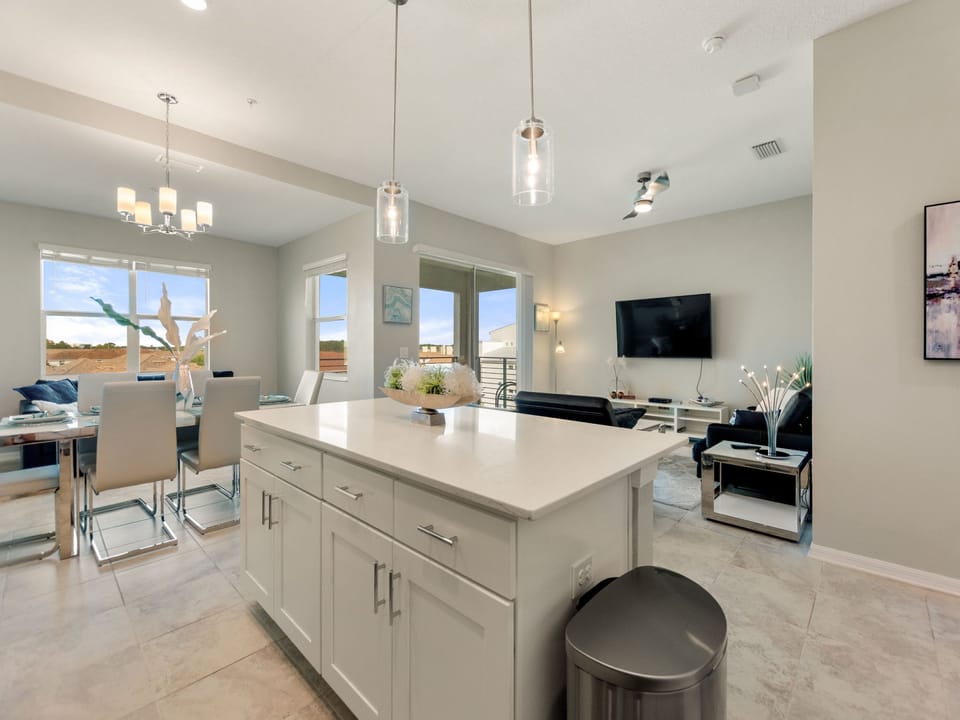 A bar height seating at the counter for 3 overlooking the living room