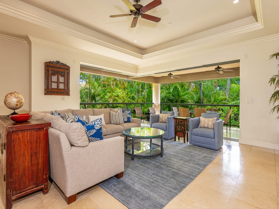 Sink into plush seating as tropical breezes drift through your open-air living room, where lush garden views frame every moment of your stay.