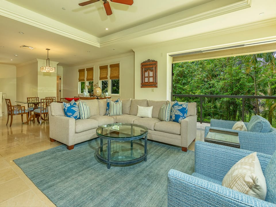 Sink into plush sofas and let tropical breezes flow through your open living space, where the lush jungle views become your personal backdrop.