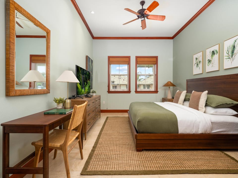 Your peaceful retreat awaits with a plush king bed, tropical wood furnishings, ceiling fan, and natural light from dual windows. Perfect for unwinding after island adventures.