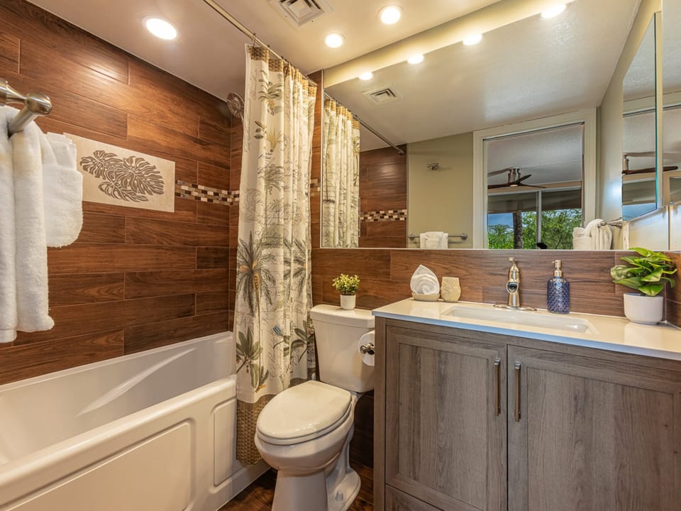 Relax in the tub surrounded by tropical paradise- primary bathroom