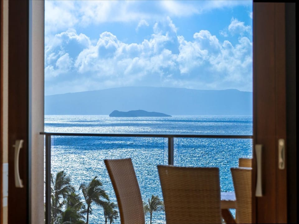 Step into your private oceanfront retreat and take in stunning sea views stretching to distant islands, with gentle waves and swaying palms just beyond your balcony.
