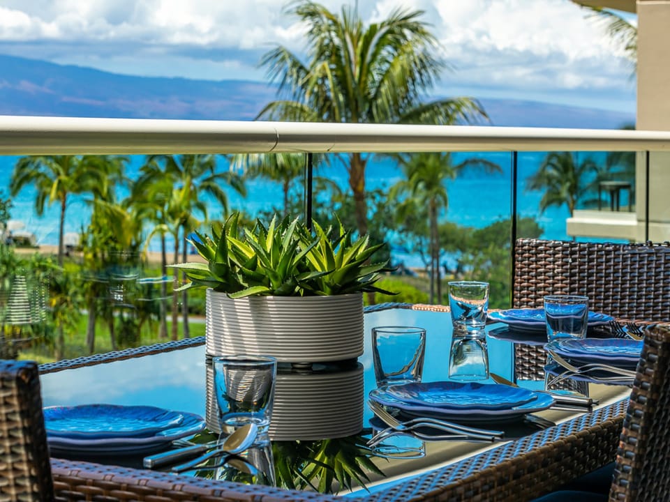 Enjoy morning coffee or sunset beverage at your private balcony table, where palm-shaded beach views and turquoise waters create the perfect backdrop for every meal.