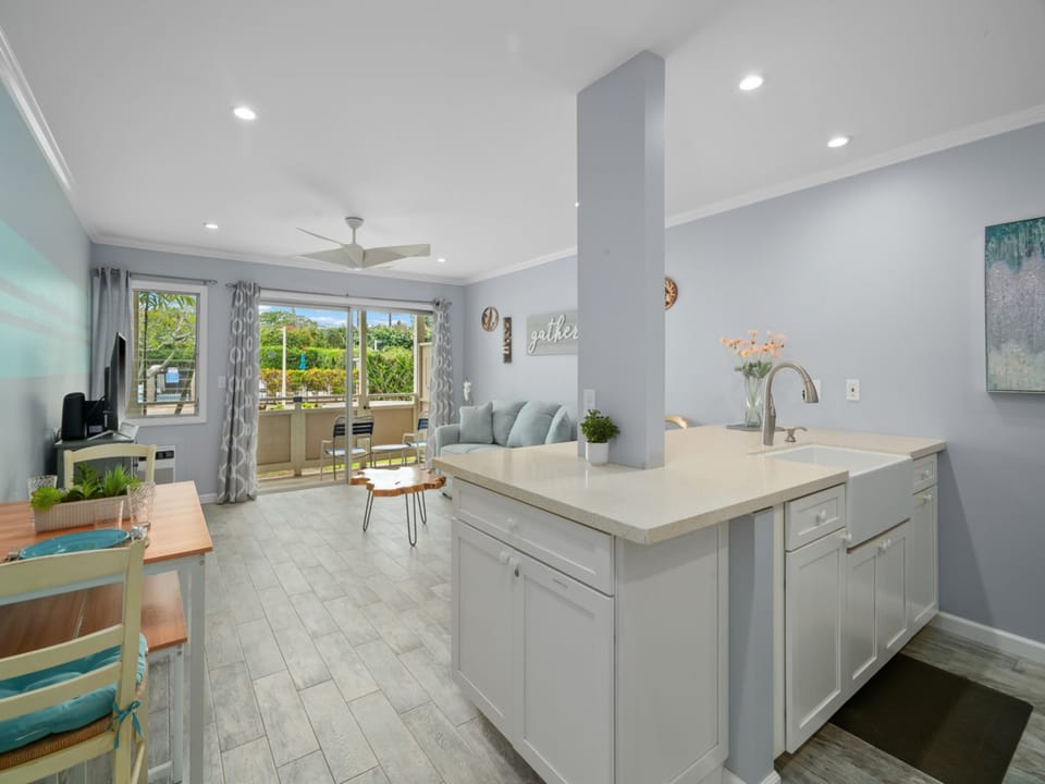 Your bright, open-concept living space invites you to relax with breezy coastal vibes, modern finishes, and a fully equipped kitchen flowing seamlessly into a cozy lounge area.