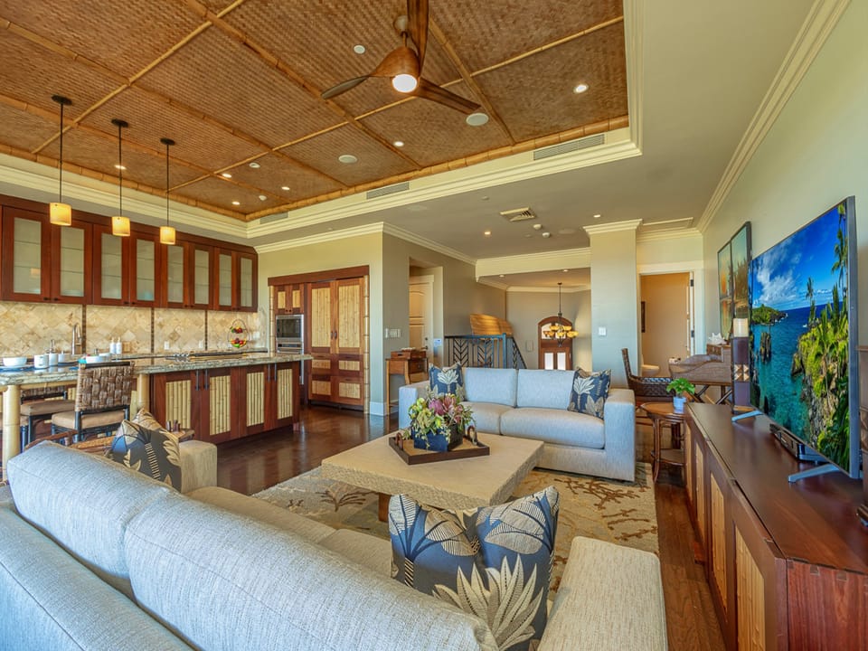 Unwind in your island-inspired living space with soaring woven ceilings, rich wood floors, and comfortable seating that flows into a gourmet kitchen—your home away from home.