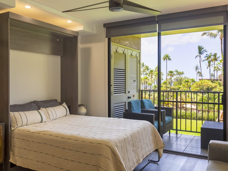 Wake up to swaying palms and lush tropical greenery right outside your window. Your private balcony offers a peaceful retreat with comfortable seating where you can sip morning coffee surrounded by paradise.