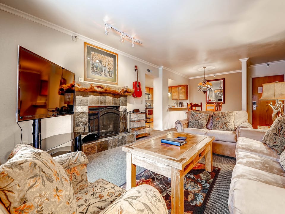 Charming living room large screen TV wood burning fireplace sleeper sofa - Park City Lodging-Park Station 236-Living Room