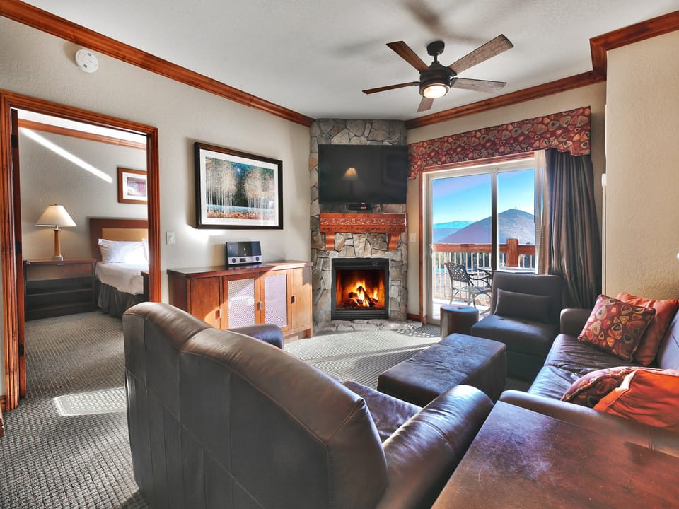 Private patio off the living room provides for beautiful natural light and mountain views