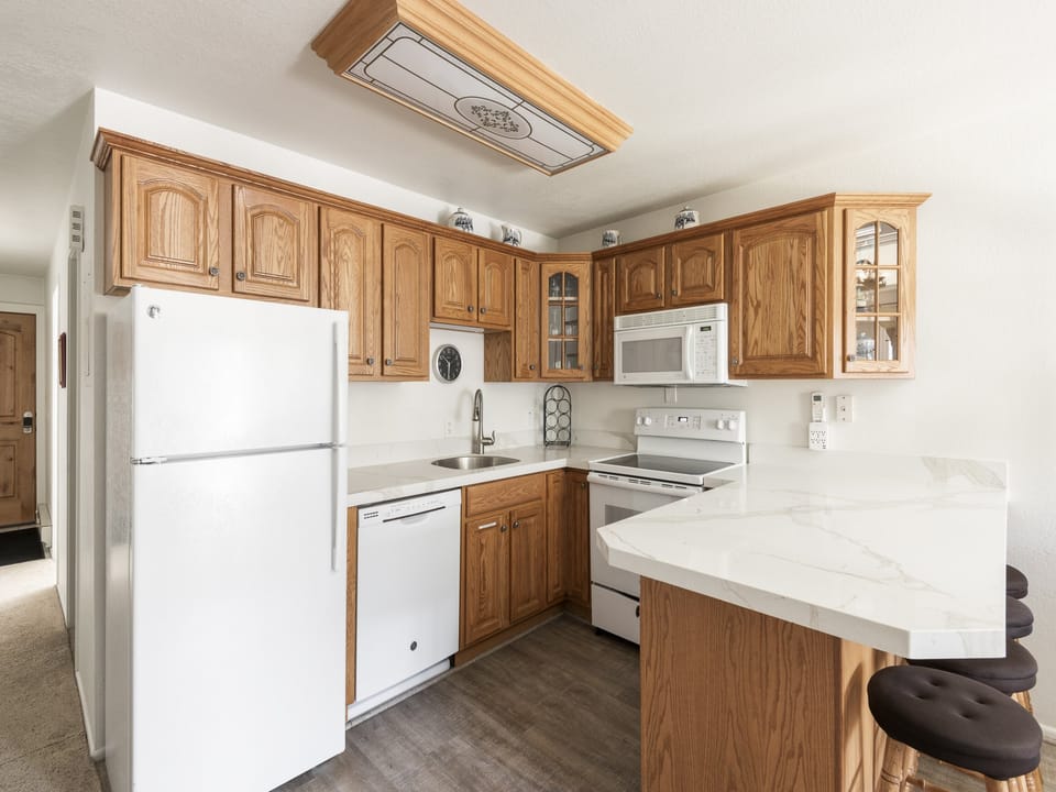 Stunning marbled granite countertops in the kitchen with seating for 4 at the bar