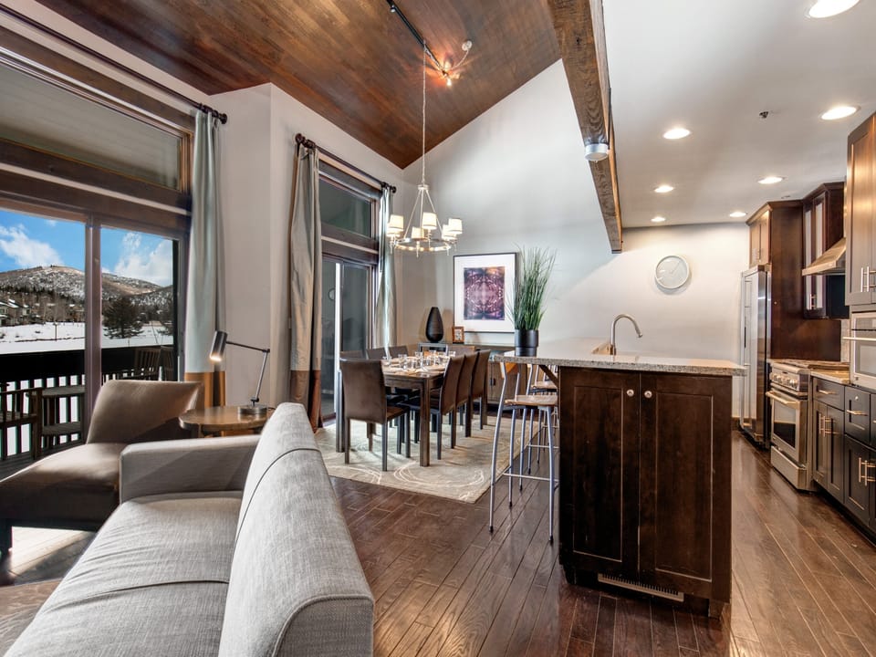 The open concept living room, dining and kitchen area with high ceilings.