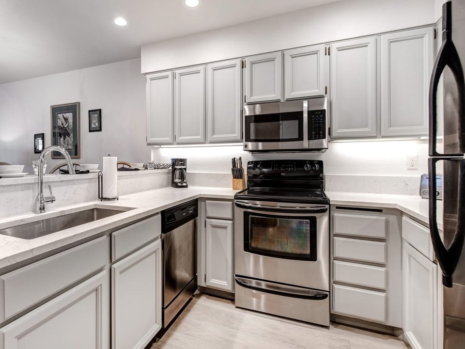 Snow Flower 152 has a well equipped kitchen with grey cabinets and stainless steel appliances.