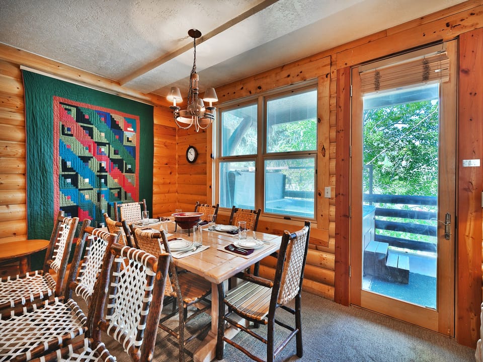 Kitchen and dining area, large picture windows for natural light and glass patio door for access to private deck