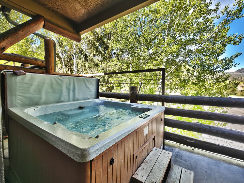 Wooden paneled hot tub with convenient steps for easy access