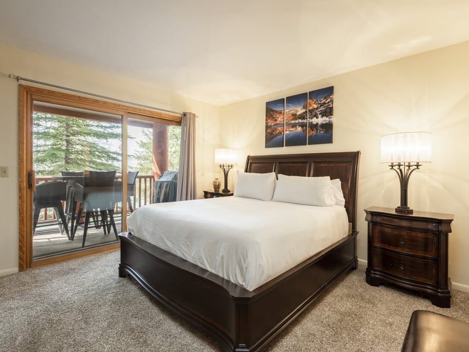 Main bedroom features a king-sized bed with access to the private patio