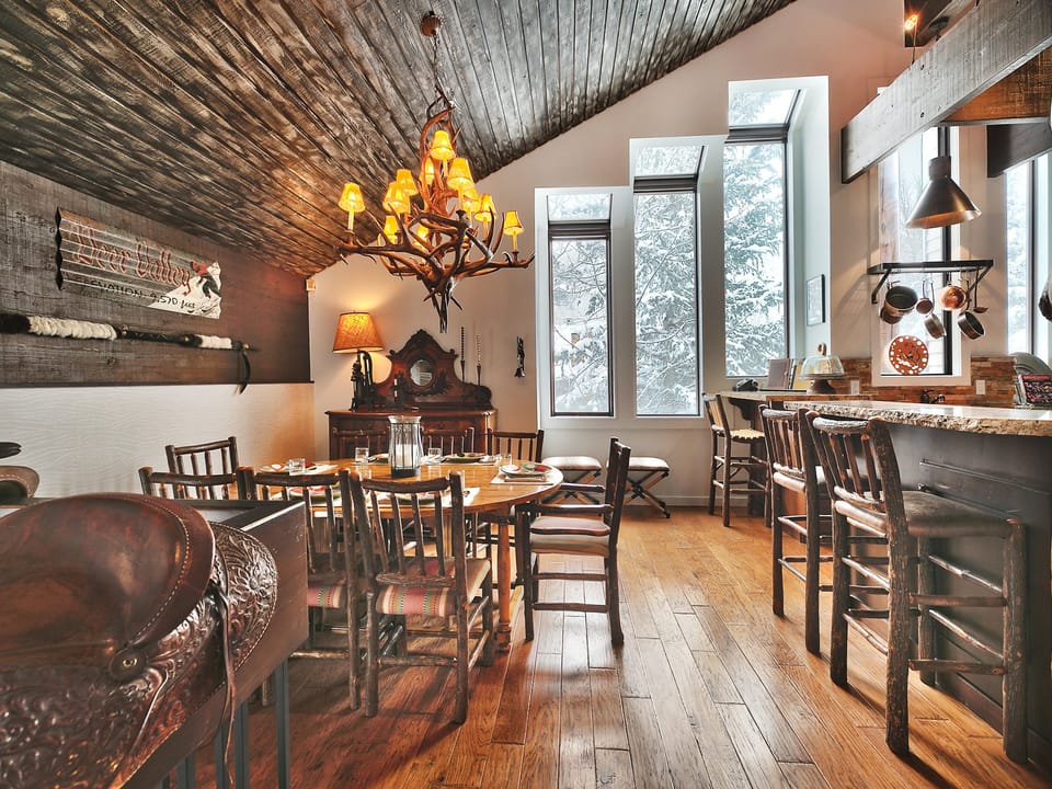 Seating for 8 at the solid wood dining room table with accent antler chandelier