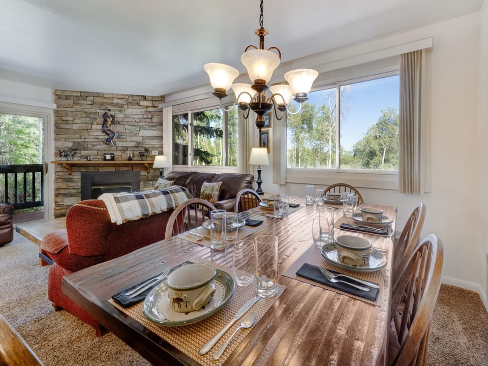 The dining area has an abundance of natural light through the picture windows