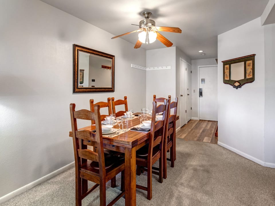 Snow Flower 12's dining areas has a solid wood table, 6 wood chairs, and is fully set with glassware, placemats, etc