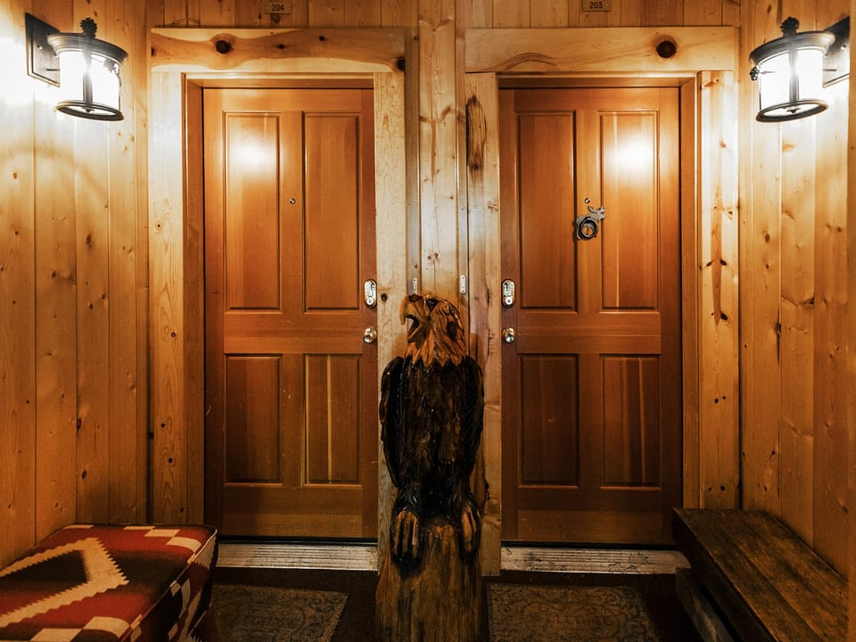 Entrance to Comstock 203 with wooden eagle sculpture