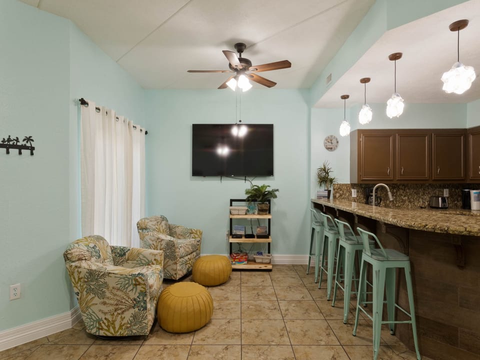 Open concept kitchen and living area surrounds a large flat screen TV !
