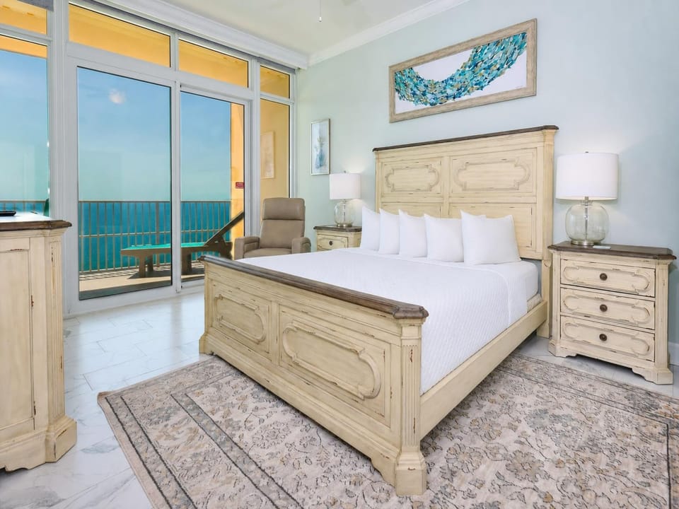 Savor gulf air from the balcony while relaxing in this king master suite with stylish decor