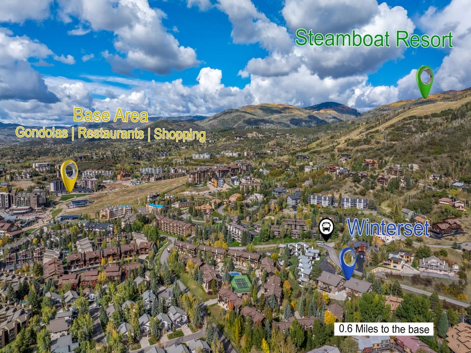Aerial view of the surrounding mountain valley resort area showing the property's location near Steamboat Resort and local amenities within 0.6 miles.
