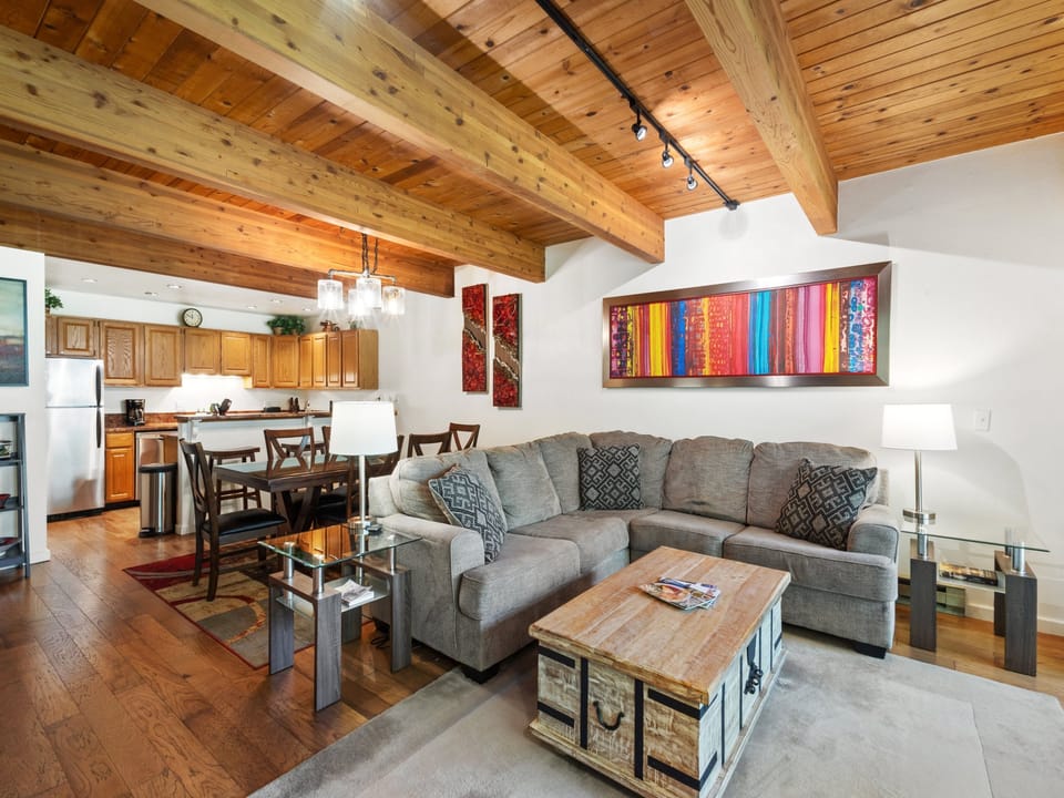 Comfortable living room with gas fireplace and access to private deck.