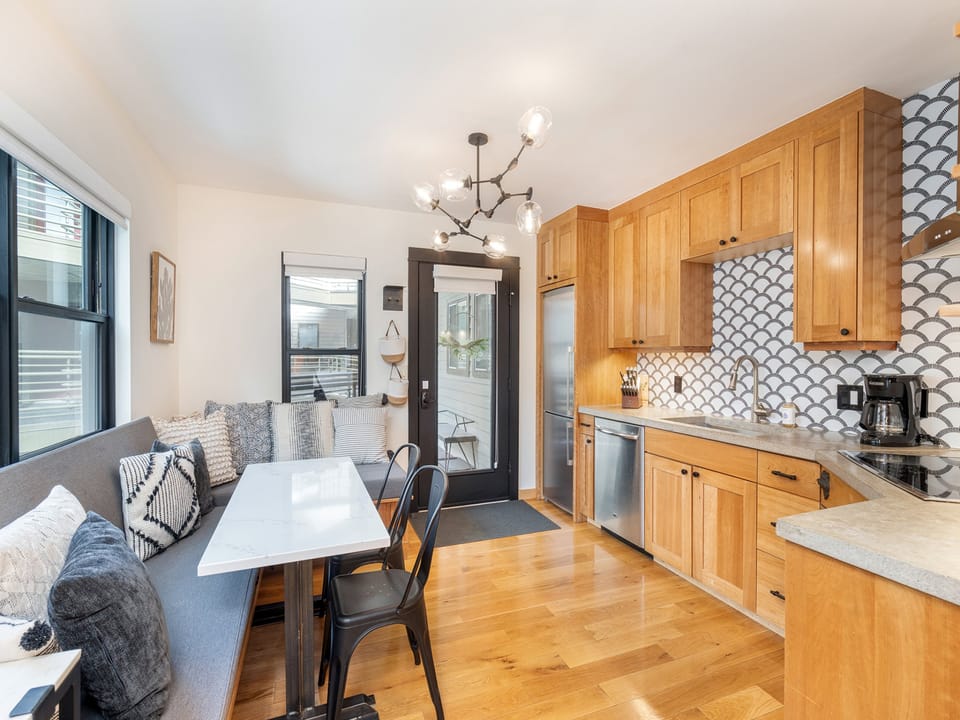 You enter into the kitchen and dining room which is modern and clean.