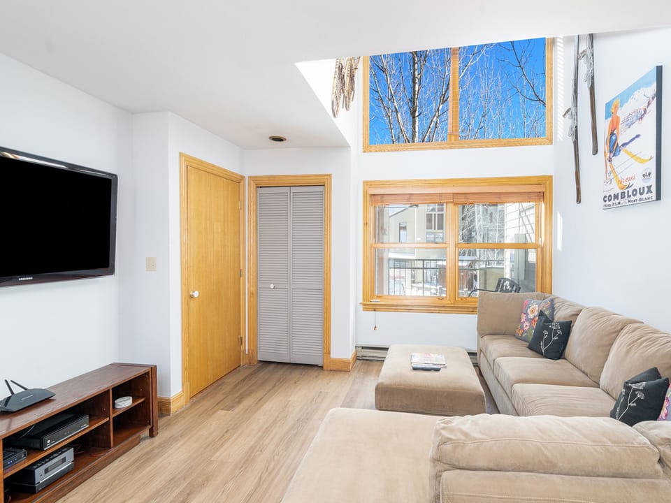 An L shaped sofa faces a flat screen TV, with views out to the Telluride Ski Resort. Lots of natural light makes this room very enjoyable.
