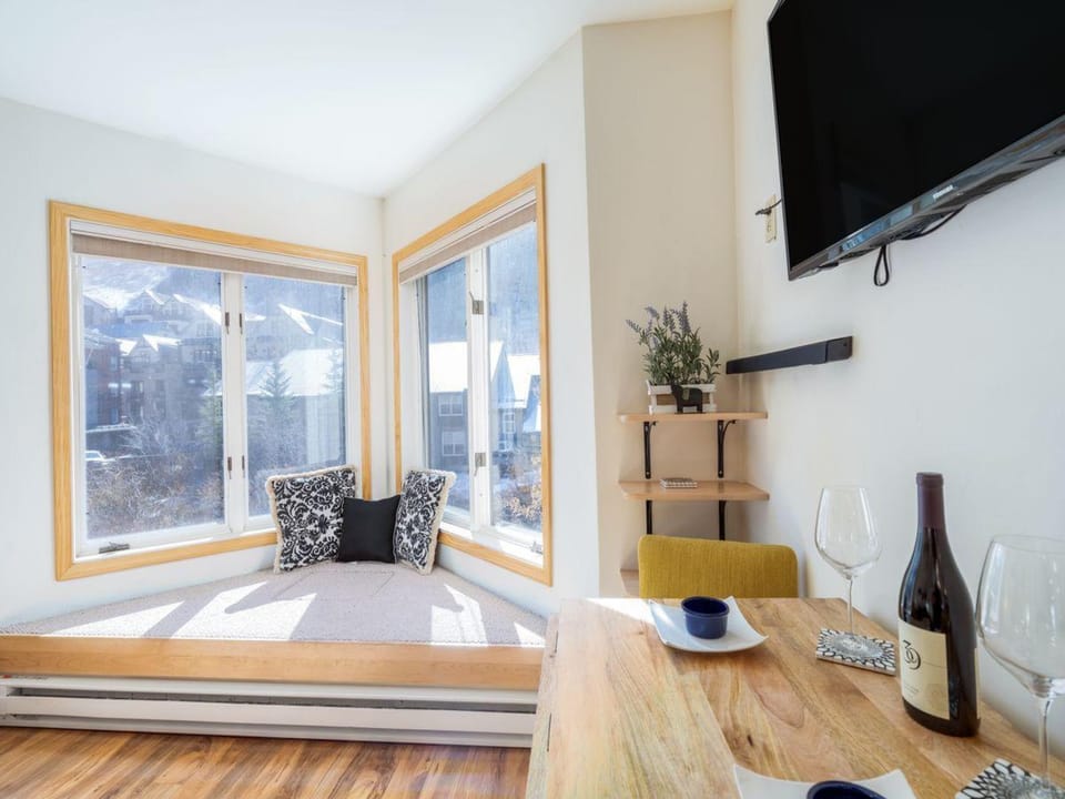The smart dining area expands to seat 4 when needed and offers views out the bay window toward the mountains.