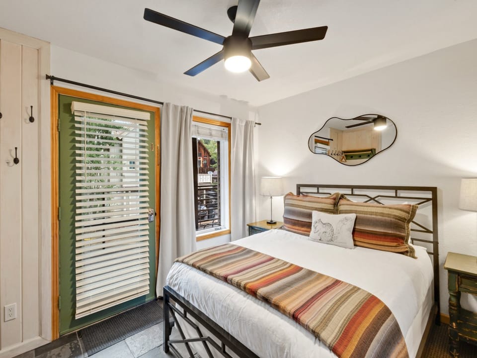 Cozy bedroom featuring a queen bed and a dresser for convenient storage.