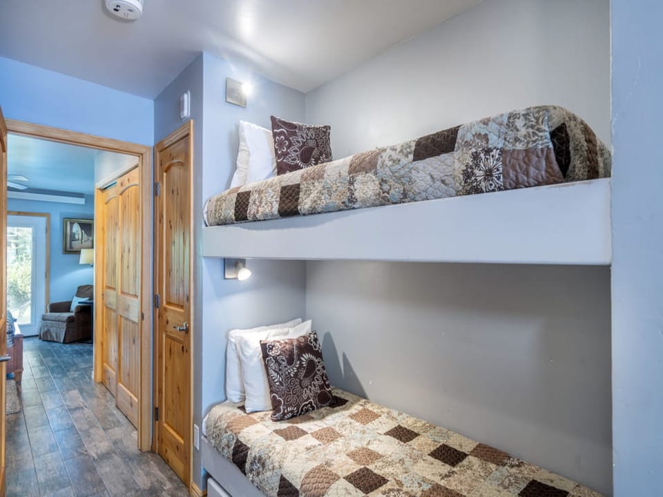 The bunk beds are in between the queen bedroom and the kitchen/living area. Please note, these are small bunk beds so really only good for kids!