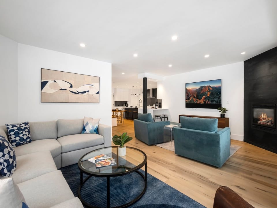 Spacious living area with TV and fireplace.