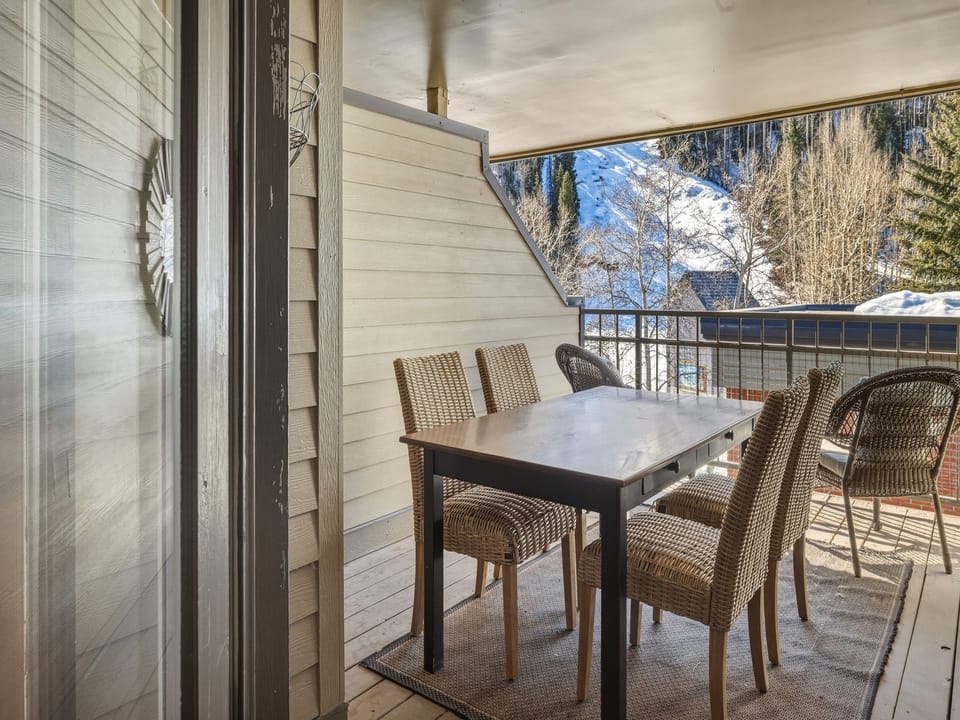 The partially covered deck off the primary bedroom is ideal for morning coffee, evening meals, or enjoying a sunset happy hour with mountain views.