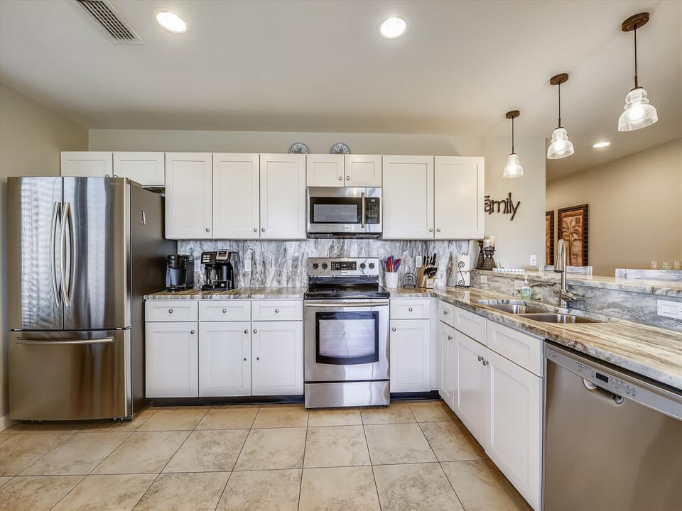 Kitchen is fully stocked and has stainless steel appliances